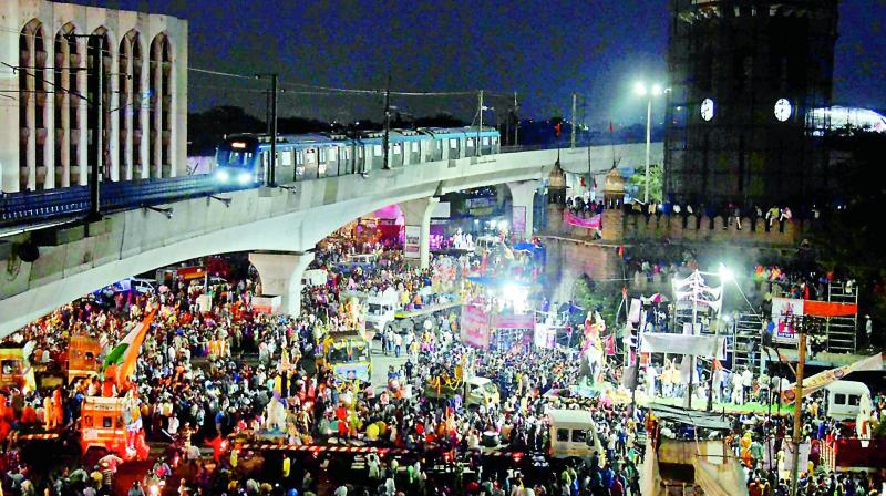 The Metro takes a trial run ahead of the launch as devotees head for the immersion at the MJ Market on Sunday. — S. Surender Reddy The Metro takes a trial run ahead of the launch as devotees head for the immersion at the MJ Market on Sunday. — S. Surender Reddy
