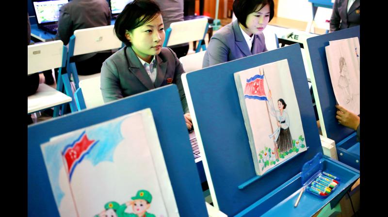 Students make story boards depicting North Korean flags being raised during a multimedia production class at Pyongyang's teacher training college, North Korea. (Photo: AP) Students make story boards depicting North Korean flags being raised during a multimedia production class at Pyongyang's teacher training college, North Korea. (Photo: AP)