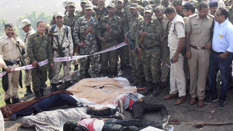 Police investigate the encounter site at the hillocks of Acharpura village after the STF killed 8 Students of Islamic Movement of India (SIMI). (Photo: PTI) Police investigate the encounter site at the hillocks of Acharpura village after the STF killed 8 Students of Islamic Movement of India (SIMI). (Photo: PTI)