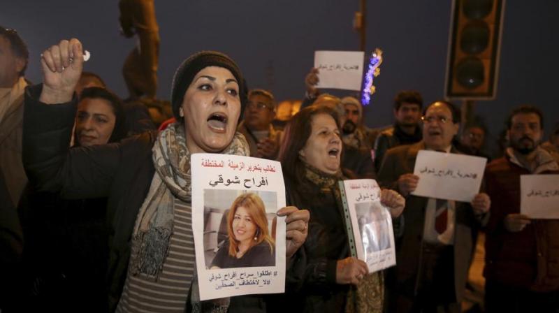 rotesters chant slogans demanding the release of kidnapped journalist Afrah Shawqi al-Qaisi, seen in posters, during a demonstration, in Baghdad. (Photo: AP) rotesters chant slogans demanding the release of kidnapped journalist Afrah Shawqi al-Qaisi, seen in posters, during a demonstration, in Baghdad. (Photo: AP)