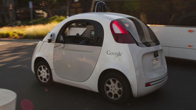 A Google self driving car drives past a double-deck commuter bus at Googles headquarters in Mountain View, CA, USA. Googles parent Alphabet, Uber, Tesla and major car makers such as BMW, Toyota, Volswagen as well as several Chinese companies have been investing in technology that eliminates the need for humans to navigate vehicles. (Photo | Wikimedia Commons - Michael Shick)