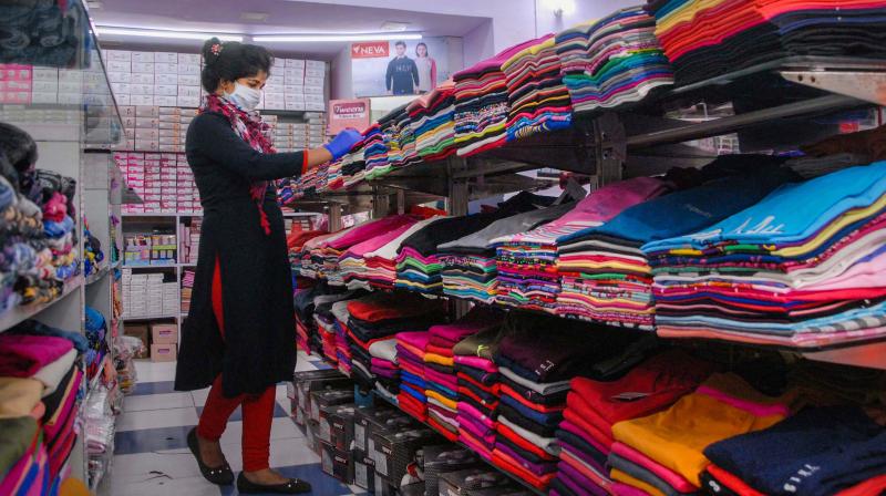 As things slowly go back to normal under Unlock 1.0, a salesperson arranges products on display at a shop inside Shopprix Mall after it reopened, in Noida, Monday, June 8, 2020. Malls and shopping centers re-opened after more than two months, focussing on hourly disinfection of the common areas, contactless shopping, and physical distancing to prevent the spread of the deadly novel coronavirus. (Photo | PTI)