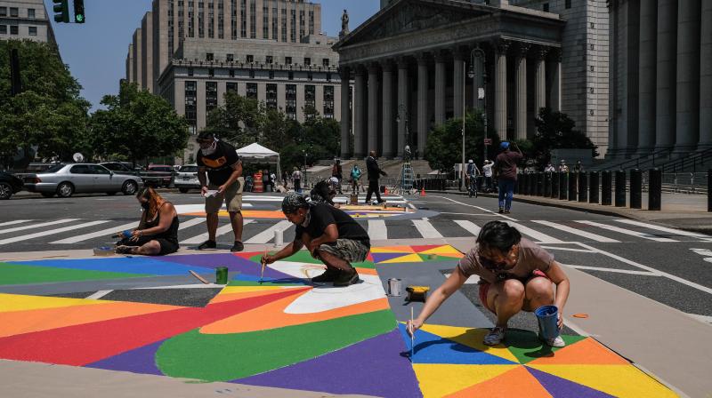 People paint a Black Lives Matter mural in front of The Manhattan courthouses on Centre Street on July 2, 2020 in New York City. Protests following the death of George Floyd have continued in New York City for more than a month. Black workers account for 3.8% of all U.S. Facebook employees and 1.5% of all U.S. technical workers at the company. Those numbers have barely budged over the past several years, a common pattern across large Silicon Valley firms. (Photo | AFP)