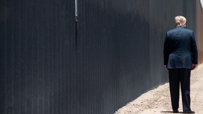 In this file photo US President Donald Trump participates in a ceremony commemorating the 200th mile of border wall at the international border with Mexico in San Luis, Arizona, June 23, 2020. (Photo |