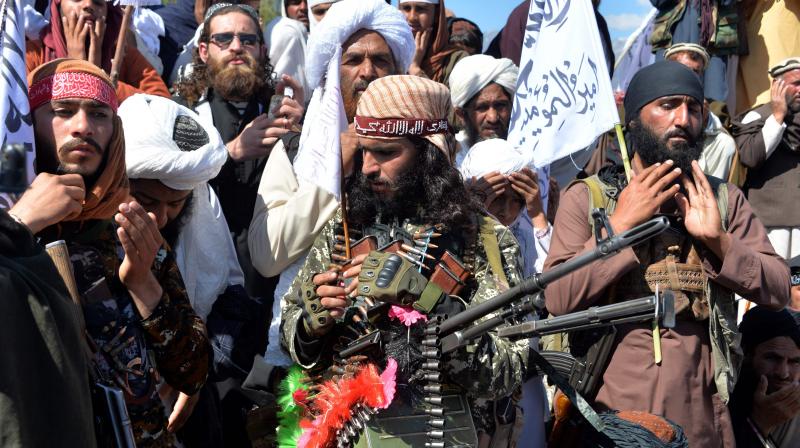 In this photo taken on March 02, 2020 Afghan Taliban militants and villagers attend a gathering as they celebrate the peace deal and their victory in the Afghan conflict on US in Afghanistan, in Alingar district of Laghman Province. Al-Qaida's regional affiliate maintains close ties to the Taliban and has an "enduring interest" in attacking US and foreign troops, the Pentagon said July 1, 2020. The Taliban is militarily and politically stronger than at any time since 2001 when it refused to hand over al-Qaida leader Osama bin Laden, who orchestrated the 9/11 attacks on the US. (Photo | AFP) In this photo taken on March 02, 2020 Afghan Taliban militants and villagers attend a gathering as they celebrate the peace deal and their victory in the Afghan conflict on US in Afghanistan, in Alingar district of Laghman Province. Al-Qaida's regional affiliate maintains close ties to the Taliban and has an "enduring interest" in attacking US and foreign troops, the Pentagon said July 1, 2020. The Taliban is militarily and politically stronger than at any time since 2001 when it refused to hand over al-Qaida leader Osama bin Laden, who orchestrated the 9/11 attacks on the US. (Photo | AFP)