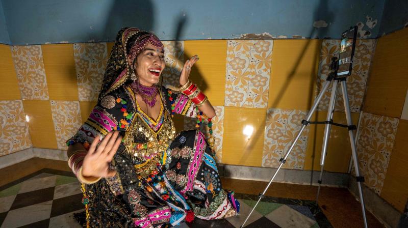 In this picture taken on August 13, 2020, Kalbeliya gypsy dancer Aasha Sapera hosts an online dance class amid the COVID-19 coronavirus pandemic in Jodhpur. The coronavirus pandemic has forced many people to go online, but the largely nomadic, marginalised Kalbeliya face bigger challenges than most, with several living in mud huts or tents with patchy electricity and non-existent WiFi. \In the beginning, I had no idea how to make this work,\ dancer Aasha Sapera told AFP, describing her early forays into hosting classes on Zoom. (Photo | AFP - Sunil Verma)