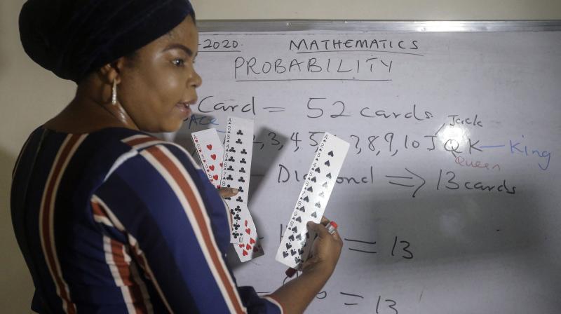 Mathematics teacher Basirat Olamide Ajayi, 36, teaches probability theory with the aid of playing cards, online via her mobile phone from her house in Lagos, Nigeria Saturday, Aug. 15, 2020. Ajayis free classes are attracting students from all over Nigeria, and now students abroad are joining. A recent request came from Canada. Ajayi says she is beginning to see herself as a global teacher. (Photo | AP)