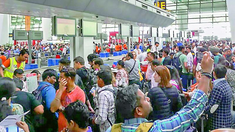 Air India flight passengers stranded at the Indira Gandhi International Airport, in New Delhi on Saturday. (PTI) Air India flight passengers stranded at the Indira Gandhi International Airport, in New Delhi on Saturday. (PTI)