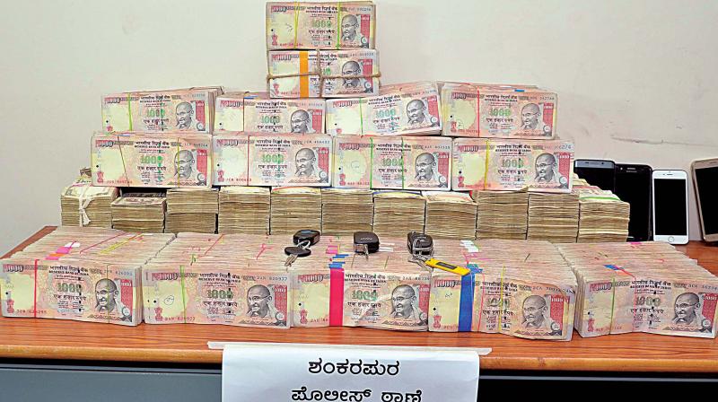 Old Rs 1000 rupees notes seized by Shankarpura police, in Bengaluru. (Photo: DC) Old Rs 1000 rupees notes seized by Shankarpura police, in Bengaluru. (Photo: DC)