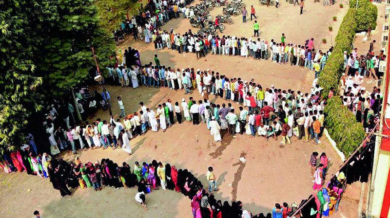 People stand in a massive queue outside a bank to exchange their old Rs 500 and Rs 1,000 notes in Varanasi on Sunday. (Photo: PTI) People stand in a massive queue outside a bank to exchange their old Rs 500 and Rs 1,000 notes in Varanasi on Sunday. (Photo: PTI)
