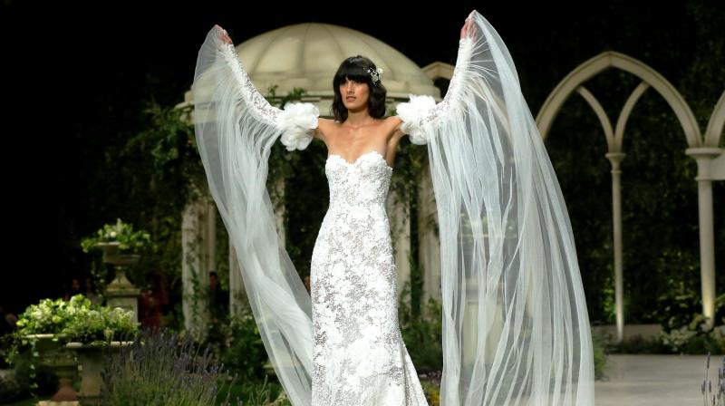 Wedding dresses with sleeves have been making a comeback for several years but statement sleeves are all the rage these days. (Photo: AP) Wedding dresses with sleeves have been making a comeback for several years but statement sleeves are all the rage these days. (Photo: AP)