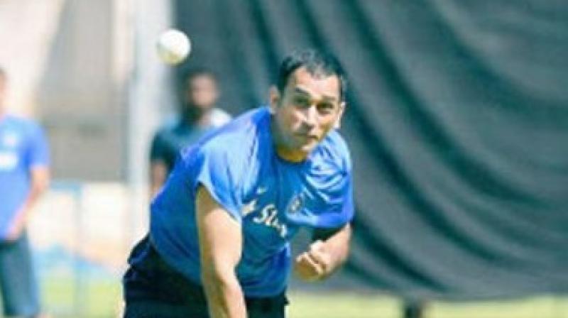 MS Dhoni rolled his arm over as he bowled to Manish Pandey during the net practice ahead of the first India versus England ODI in Pune. (Photo: Screengrab) MS Dhoni rolled his arm over as he bowled to Manish Pandey during the net practice ahead of the first India versus England ODI in Pune. (Photo: Screengrab)