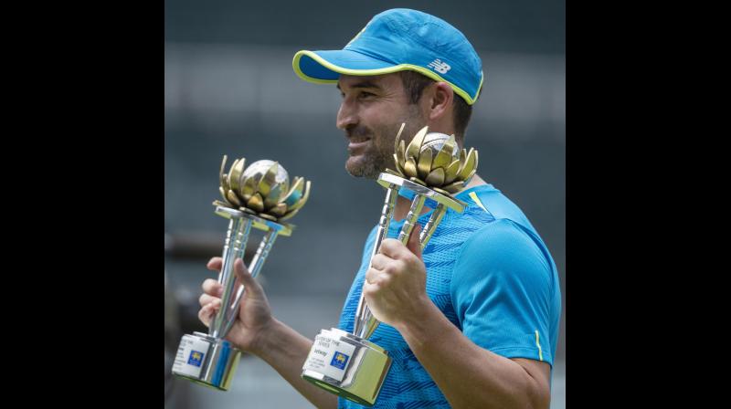 South Africas Dean Elgar holds the  Man of the Match and the Series  trophies at the end of play on the third day of the second cricket Test match between South Africa and Sri Lanka at Wanderers stadium in Johannesburg, South Africa, on Tuesday. - AP .