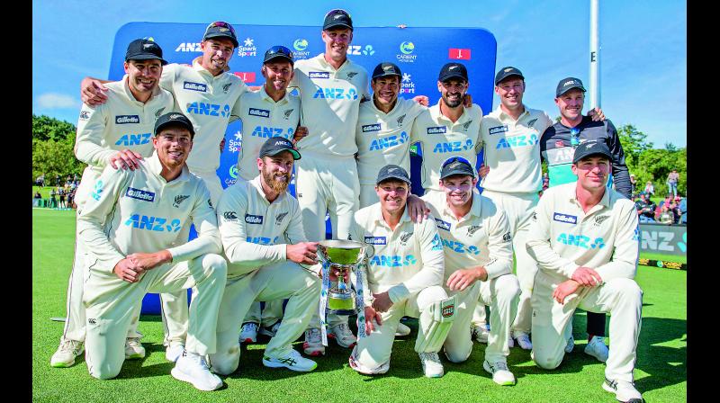 New Zealand players pose for a team photo with their trophy after defeating Pakistan to claim series 2-0 at Hagley Oval in Christchurch, New Zealand, on Wednesday. — AFP New Zealand players pose for a team photo with their trophy after defeating Pakistan to claim series 2-0 at Hagley Oval in Christchurch, New Zealand, on Wednesday. — AFP