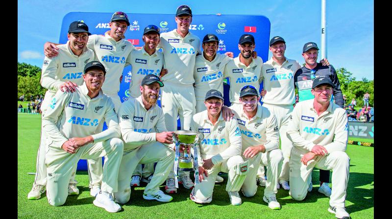 New Zealand players pose for a team photo with their trophy after defeating Pakistan to claim series 2-0 at Hagley Oval in Christchurch, New Zealand, on Wednesday. 	 AFP