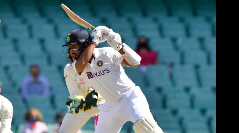 Indian batsman Cheteshwar Pujara  plays a shot on Day Three of the third Test match at the Sydney Cricket Ground on Saturday. -- AFP