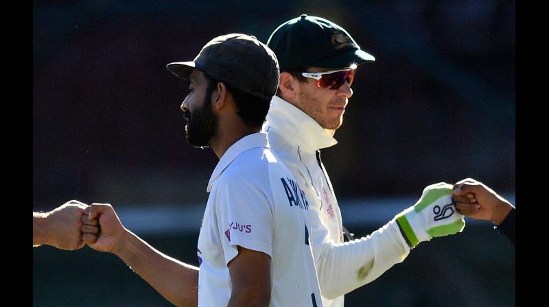 India’s captain Ajinkya Rahane (left) and Australia’s captain Tim Paine greet at the end of the third cricket Test match between Australia and India at the Sydney Cricket Ground on Monday. -- AFP India’s captain Ajinkya Rahane (left) and Australia’s captain Tim Paine greet at the end of the third cricket Test match between Australia and India at the Sydney Cricket Ground on Monday. -- AFP