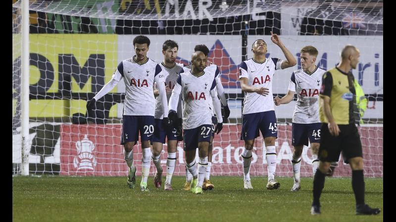 Carlos Vinicius of Tottenham Hotspur points to the sky as he celebrates scoring his sides first goal against Marine during their English FA Cup match at Rossett Park stadium in Crosby, Liverpool, on Sunday. -- AP