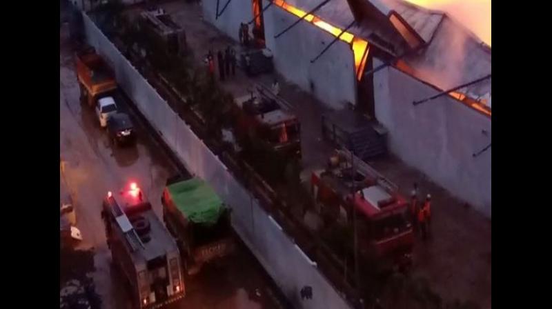As many as six fire tenders rushed to the spot and firemen are attempting to douse the flames. (Photo: ANI) As many as six fire tenders rushed to the spot and firemen are attempting to douse the flames. (Photo: ANI)