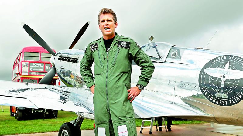 British aviator Matt Jones in front of a restored World War II Silver Spitfire plane before take off at Goodwood Aerodrome in Chichester, England, on Monday. —AFP British aviator Matt Jones in front of a restored World War II Silver Spitfire plane before take off at Goodwood Aerodrome in Chichester, England, on Monday. —AFP