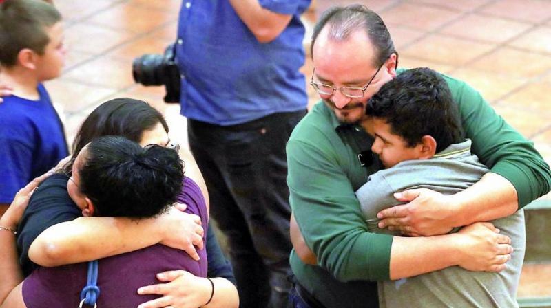 People hug at St Pius X Church at a vigil for victims after a mass shooting which left at least 20 people dead on Sunday in El Paso, Texas. (Photo: AFP) People hug at St Pius X Church at a vigil for victims after a mass shooting which left at least 20 people dead on Sunday in El Paso, Texas. (Photo: AFP)