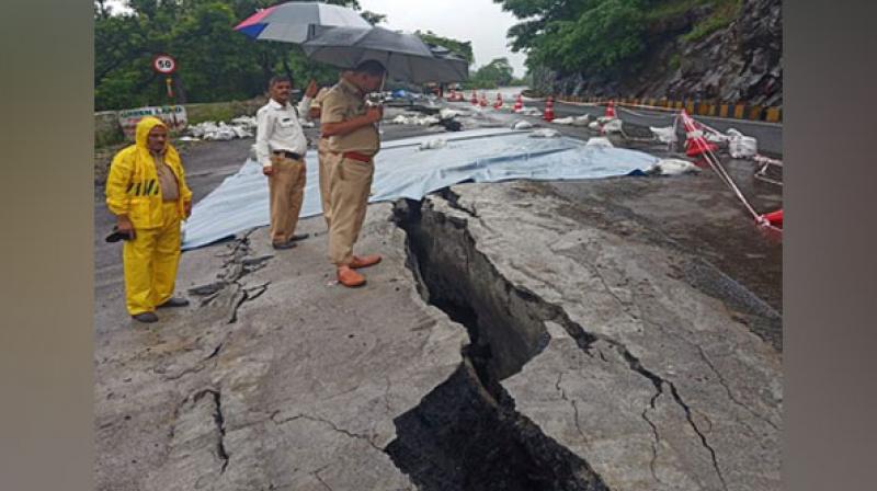 Traffic on the state highway connecting Mangalore to neighbouring states came to a halt on Tuesday after a huge crack developed in the road, due to incessant rains. (Photo: ANI) Traffic on the state highway connecting Mangalore to neighbouring states came to a halt on Tuesday after a huge crack developed in the road, due to incessant rains. (Photo: ANI)
