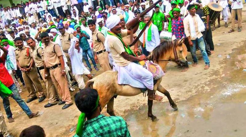 An Adivasi man, carrying a wooden rifle, rides his horse at the venue of the International Adivasi Day at Jainoor in Kumarambheem Asifabad district on Friday. many Adivasis had to wait outside as there was no space inside the hall. —DC An Adivasi man, carrying a wooden rifle, rides his horse at the venue of the International Adivasi Day at Jainoor in Kumarambheem Asifabad district on Friday. many Adivasis had to wait outside as there was no space inside the hall. —DC