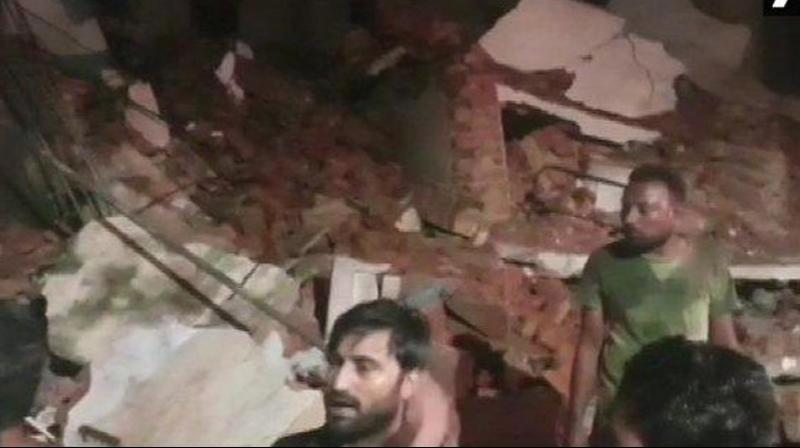 At least four people died after a three-storey apartment building in Pragatinagar in Gujarat’s Nadiad collapsed on Friday night. (Photo: ANI) At least four people died after a three-storey apartment building in Pragatinagar in Gujarat’s Nadiad collapsed on Friday night. (Photo: ANI)