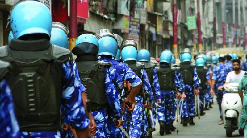 Rapid Action Force personnel patrol a street during restrictions in Jammu on Friday. Restrictions have been imposed in several districts J&K after the state lost its special status. (Photo: PTI) Rapid Action Force personnel patrol a street during restrictions in Jammu on Friday. Restrictions have been imposed in several districts J&K after the state lost its special status. (Photo: PTI)