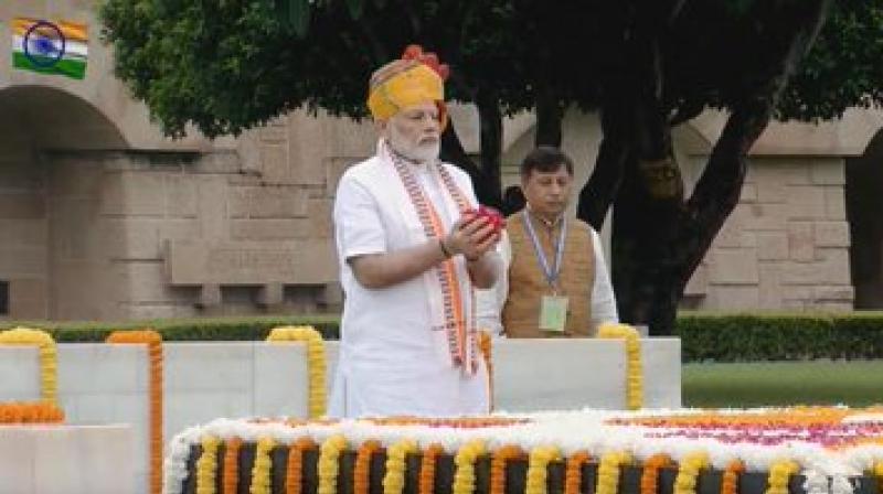 Prime Minister Narendra Modi paid homage to Mahatma Gandhi at the Rajghat on the occasion of Independence Day on Thursday, prior to the flag hoisting at the Red Fort. (Photo: Twitter/ ANI) Prime Minister Narendra Modi paid homage to Mahatma Gandhi at the Rajghat on the occasion of Independence Day on Thursday, prior to the flag hoisting at the Red Fort. (Photo: Twitter/ ANI)