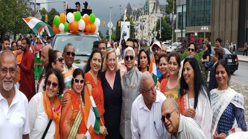 Dressed in traditional Indian attire, people marched from the Parliament to City Hall in Ottawa with gaiety and enthusiasm. (Photo: ANI) Dressed in traditional Indian attire, people marched from the Parliament to City Hall in Ottawa with gaiety and enthusiasm. (Photo: ANI)