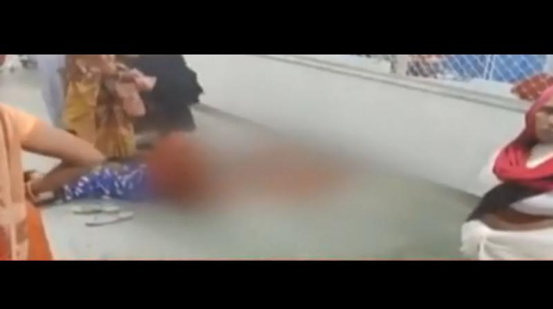 The horrific visuals of the woman lying in the hospital corridor with blood all around her can be seen in the video shot on a mobile camera. (NDTV/ youtube video screen) The horrific visuals of the woman lying in the hospital corridor with blood all around her can be seen in the video shot on a mobile camera. (NDTV/ youtube video screen)
