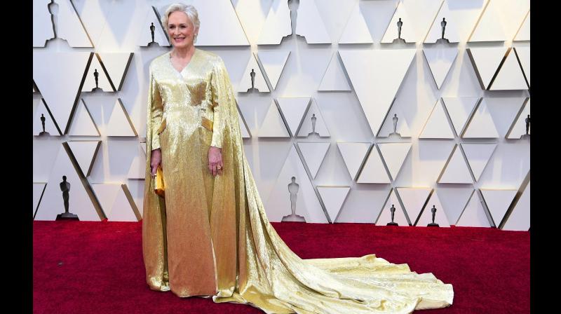 The Wife star in 40lbs golden Cape dress by Carolina Herrera. (Photo: AP) The Wife star in 40lbs golden Cape dress by Carolina Herrera. (Photo: AP)