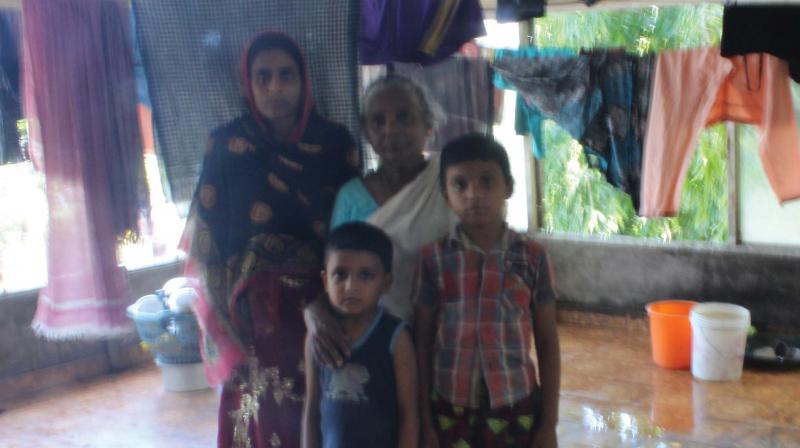Sajna and her children along with Vasundhara at the rooftop of the former Purakkad panchayat building on Saturday Sajna and her children along with Vasundhara at the rooftop of the former Purakkad panchayat building on Saturday