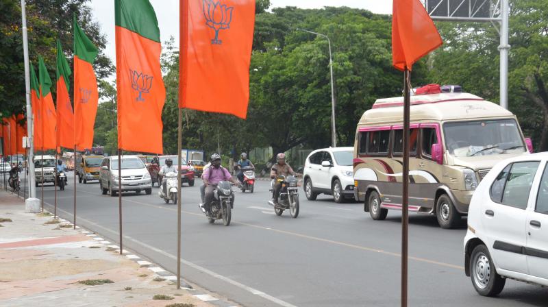 Flags greeting BJP national president Amit Shah dotted the stretch from Chennai airport to VGP s golden beach resort on Monday. The flags in front of the metro rail at Alandur posed a hardship to pedestrians. (Photo: DC) Flags greeting BJP national president Amit Shah dotted the stretch from Chennai airport to VGP s golden beach resort on Monday. The flags in front of the metro rail at Alandur posed a hardship to pedestrians. (Photo: DC)