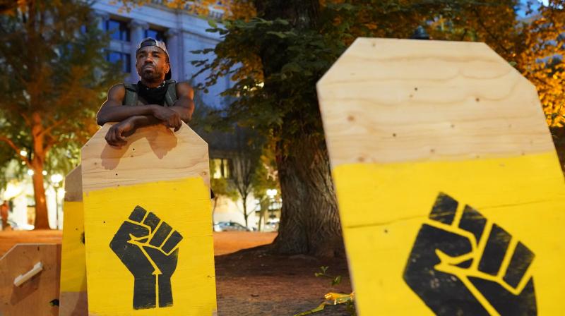 A protester rests on a protest shield. (AFP) A protester rests on a protest shield. (AFP)