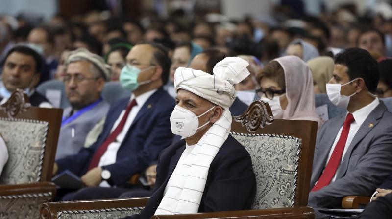 Afghan President Ashraf Ghani, center, wearing a protective face mask to help curb the spread of the coronavirus, attends the first day of the Afghan Loya Jirga meeting in Kabul. (AP)
