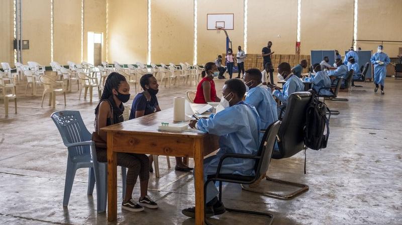 Nurses collect the data of people about to get tested for COVID-19 at a testing center in the capital Kigali, Rwanda. (AP)