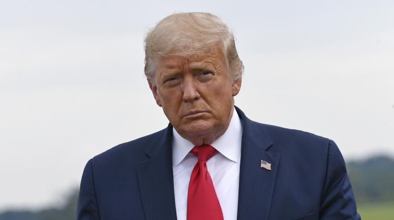 US President Donald Trump walks over to speak with the press after arriving on Air Force One at Morristown Municipal Airport in Morristown. (AP)
