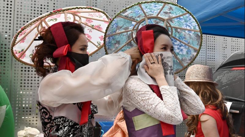 Models wearing face masks prepare backstage prior to a mask fashion show at Gangnam district in Seoul. (AFP)