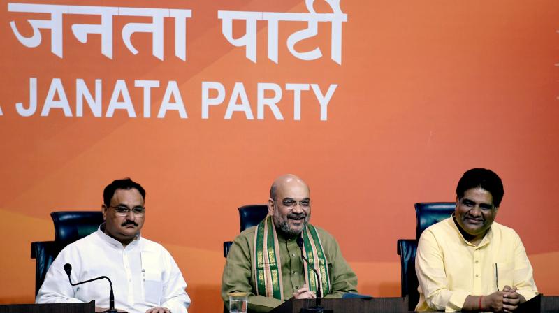BJP President Amit Shah with party leaders JP Nadda and Bhupender Yadav. (Photo: PTI) BJP President Amit Shah with party leaders JP Nadda and Bhupender Yadav. (Photo: PTI)