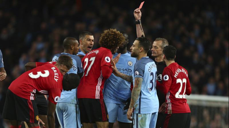 Booked for tripping Sergio Aguero in the 85th minute, Marouane Fellaini fouled him again seconds later and then blatantly butted the Argentinian, leaving referee Martin Atkinson no option but to send the Belgian off. (Photo: AP) Booked for tripping Sergio Aguero in the 85th minute, Marouane Fellaini fouled him again seconds later and then blatantly butted the Argentinian, leaving referee Martin Atkinson no option but to send the Belgian off. (Photo: AP)