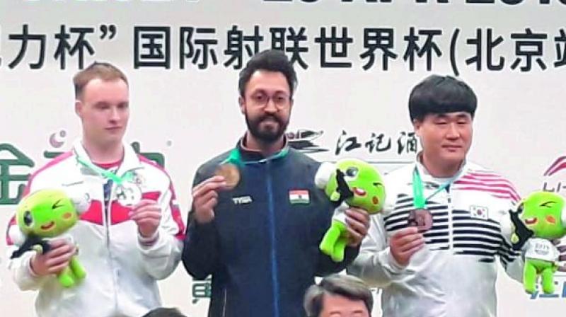 Abhishek Verma poses with his gold medal atop the podium at the ISSF World Cup in Beijing. Abhishek Verma poses with his gold medal atop the podium at the ISSF World Cup in Beijing.