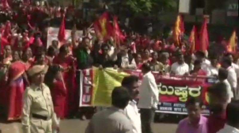 The 10 central trade unions (CTUs) which have given a call for the two-day Bharat Bandh are protesting the government's snub of their 12-point charter of demands seeking minimum wage of Rs 18,000, social security for all workers and issue related to price rise. (Photo: ANI | Twitter) The 10 central trade unions (CTUs) which have given a call for the two-day Bharat Bandh are protesting the government's snub of their 12-point charter of demands seeking minimum wage of Rs 18,000, social security for all workers and issue related to price rise. (Photo: ANI | Twitter)