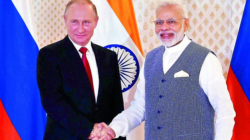 Russian President Vladimir Putin being welcomed by Prime Minister Narendra Modi ahead of the 17th India-Russia annual summit in Benaulim, Goa, on Saturday. (Photo: PTI) Russian President Vladimir Putin being welcomed by Prime Minister Narendra Modi ahead of the 17th India-Russia annual summit in Benaulim, Goa, on Saturday. (Photo: PTI)