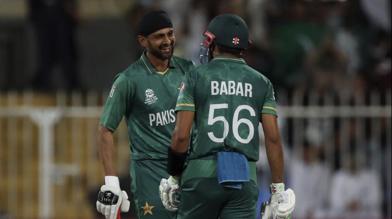 Pakistan's Shoaib Malik (left) celebrates with captain Babar Azam after hitting a boundary during the T20 World Cup match against Scotland in Sharjah on Sunday. (AP Photo) Pakistan's Shoaib Malik (left) celebrates with captain Babar Azam after hitting a boundary during the T20 World Cup match against Scotland in Sharjah on Sunday. (AP Photo)