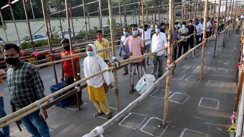 People maintain social distance as they queue to enter APMC fruit market during the nationwide lockdown to curb the spread of coronavirus, in Navi Mumbai. PTI photo