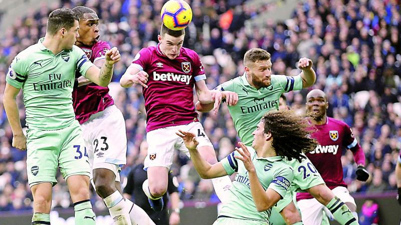 West Ham’s Declan Rice (centre) tries to head the ball at the goal in their English Premier League match against Arsenal at the London Stadium on Saturday. West Ham won 1-0. (Photo: AP) West Ham’s Declan Rice (centre) tries to head the ball at the goal in their English Premier League match against Arsenal at the London Stadium on Saturday. West Ham won 1-0. (Photo: AP)