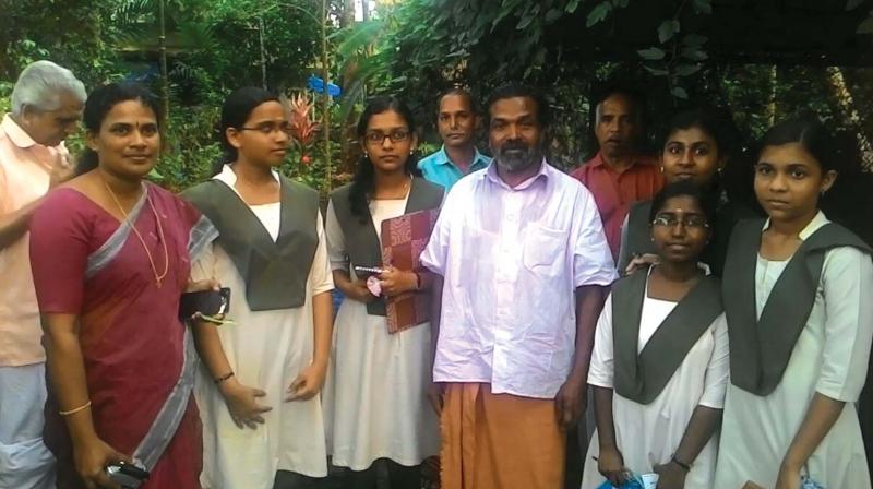 Students of GHSS Kokkallur with traditional farmer Cheruvayal Raman and teacher Sindhu E.S at Kottanada Vayal. Students of GHSS Kokkallur with traditional farmer Cheruvayal Raman and teacher Sindhu E.S at Kottanada Vayal.