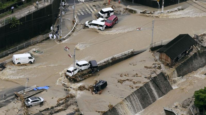 Roads are covered in mud waters after a landslide caused by heavy rains in Aki, Hiroshima prefecture, southwestern Japan. (Photo: AP) Roads are covered in mud waters after a landslide caused by heavy rains in Aki, Hiroshima prefecture, southwestern Japan. (Photo: AP)